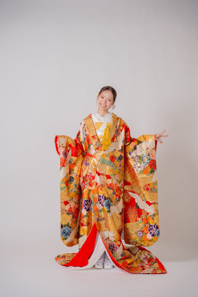 華やかな色打掛を纏い、満面の笑みを浮かべる新婦のソロショット
